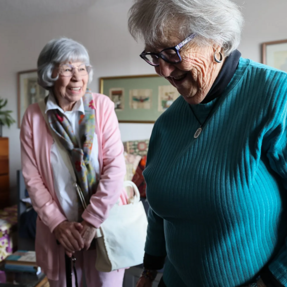 Two older adults in a room
