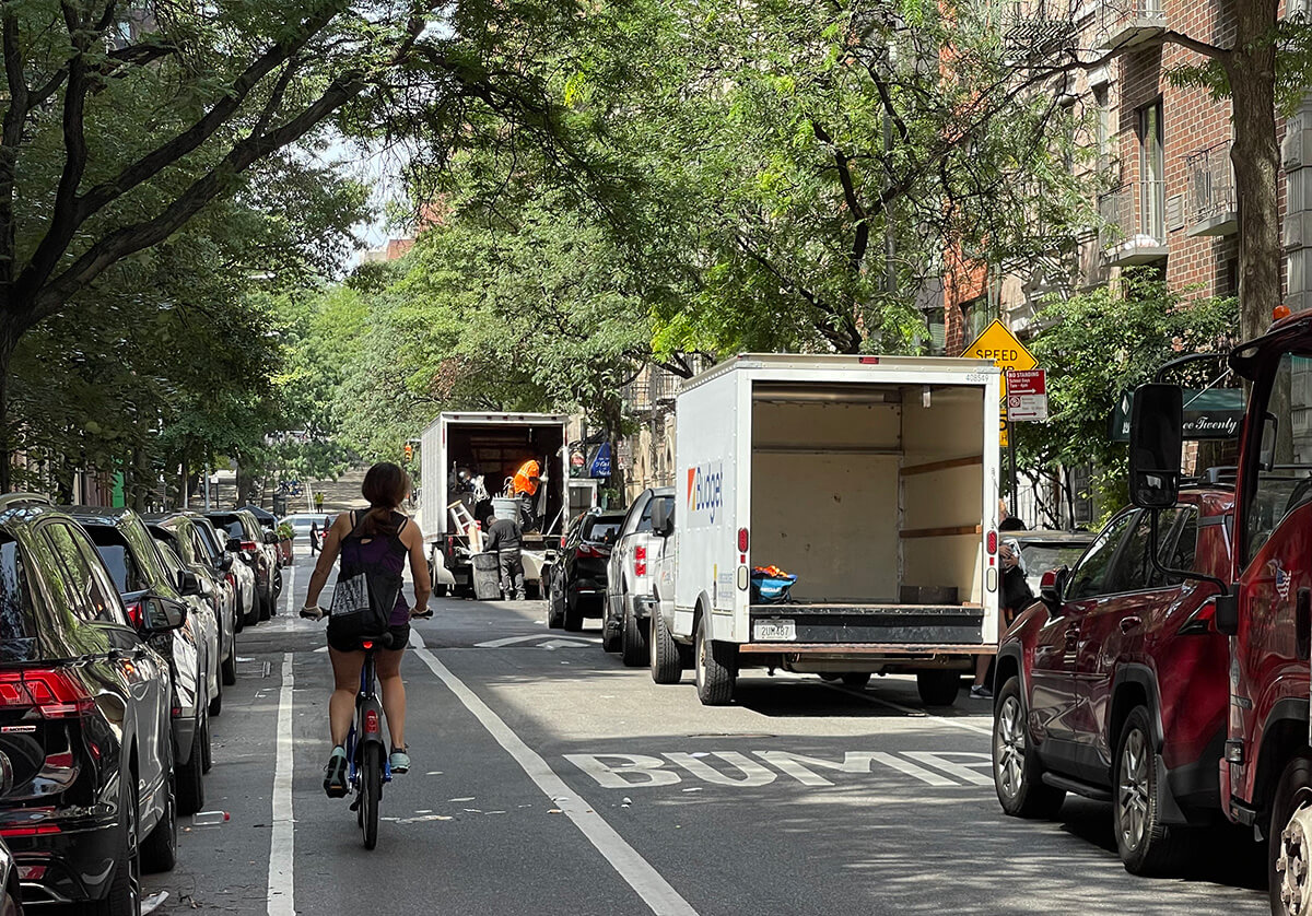 Moving trucks on a city street.