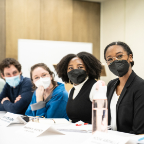 Students wearing masks talking to HUD Secretary
