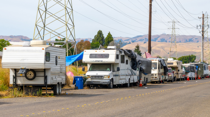 A row of RVs along the side of a road.