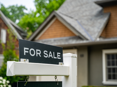 For sale sign in front of a home.