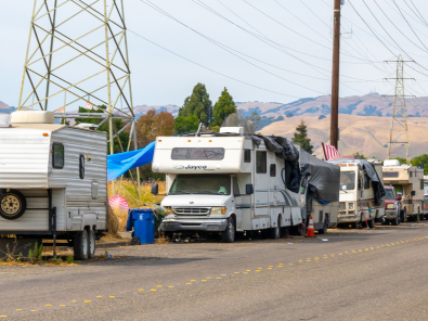 A row of RVs along the side of a road.