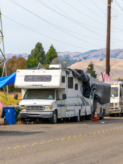 A row of RVs along the side of a road.