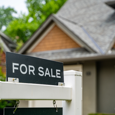 For sale sign in front of a home.