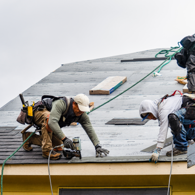 Workers repairing a damaged roof.