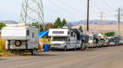 A row of RVs along the side of a road.