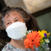 Older adult woman wearing a mask.