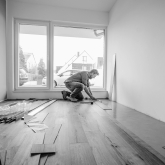Man installing wood floor.