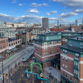 View of buildings in Central Square, Cambridge, with Boston skyline in the distance.