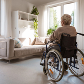Person using wheelchair in an apartment.