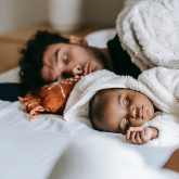 Father and young daughter taking a nap.