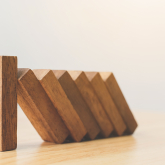 Row of blocks falling in a domino pattern.