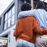 Black couple looking at a house.