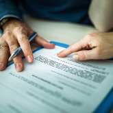 Person filling out paperwork.