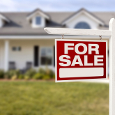 For sale sign in front of a home.