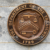 US Treasury seal on a wall.