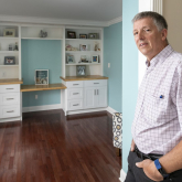 Man standing inside his home, showing remodeling project
