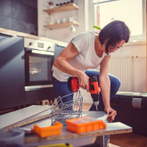 Woman using cordless drill