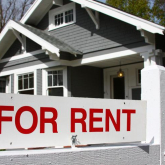 For rent sign outside of single-family home.