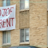 Apartment building with No Job, No Rent signs