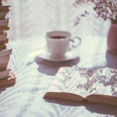 Sunny desk with open book.