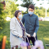 Older woman walking with young man.