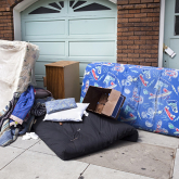 Family's belongings outside house after eviction.