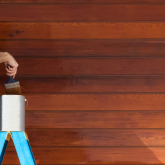 Man painting the outside of a house