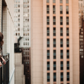 Woman on balcony in New York City.