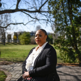Geriatric social worker Regina Smith standing outside in a park.