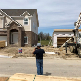 Houses under construction on a residential street.