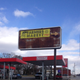 Advertisement for Brightmoor’s farmers market, in between a vacant field and a gas station.