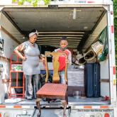 Tasharn Richardson's 11-year-old son, Lionel, helps unload the moving truck at their new home in Washington, DC.