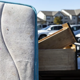 Stack of belongings in residential parking lot.
