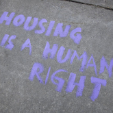 Graffiti stating "housing is a human right."