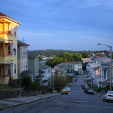 Residential street with triple decker housing.