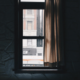 Apartment window looking out on the street.