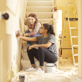 Two women looking at paint colors for a remodel