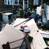 People clean up their flooded homes in Queens, New York, after the remnants of Ida passed through the area. 