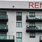 A multifamily building with a RENT sign
