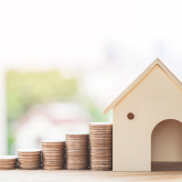 House with increasing piles of coins