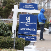 For-sale sign on residential street.