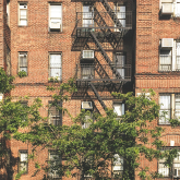 View of apartment building with air conditioners.