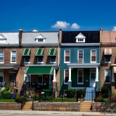 Four rowhouses facing street.