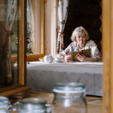 Older woman reading at a table 