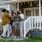 Family assembled on front steps of home.
