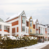 View of snowy apartment complex.