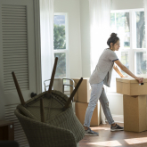 Woman unpacking boxes in new home.