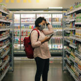 Person standing in grocery store aisle.