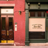 View of empty storefront on street.